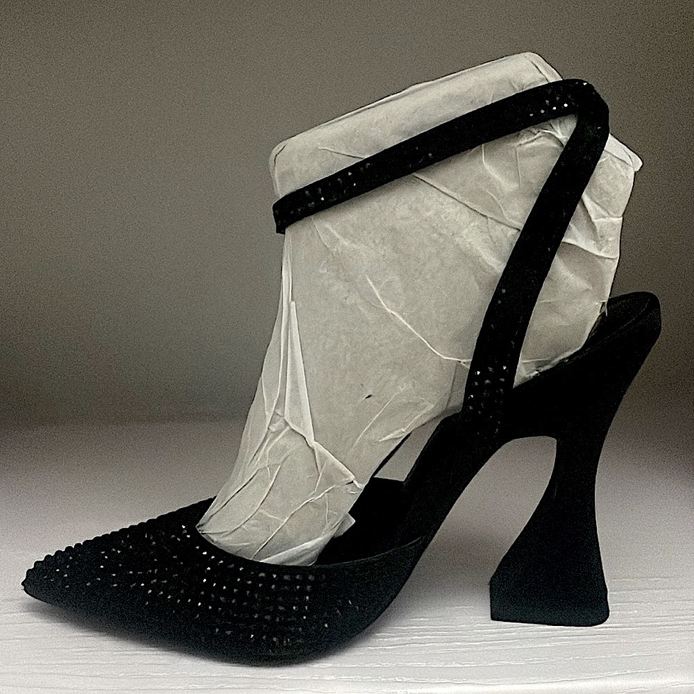 A pointy toe and flared block heel, an adjustable strap at the ankle